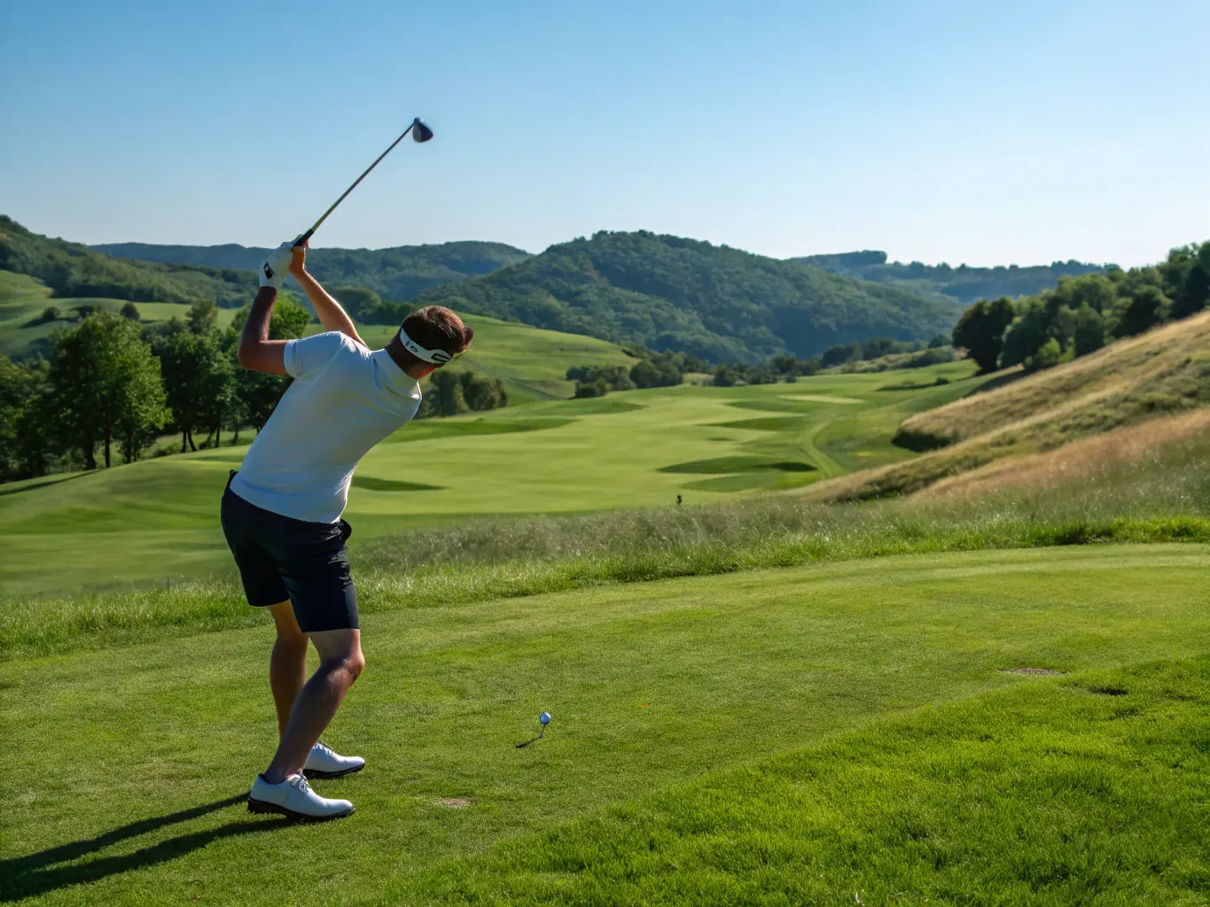 A golfer swinging a club with perfect form, highlighting the professional training available at ASGC.